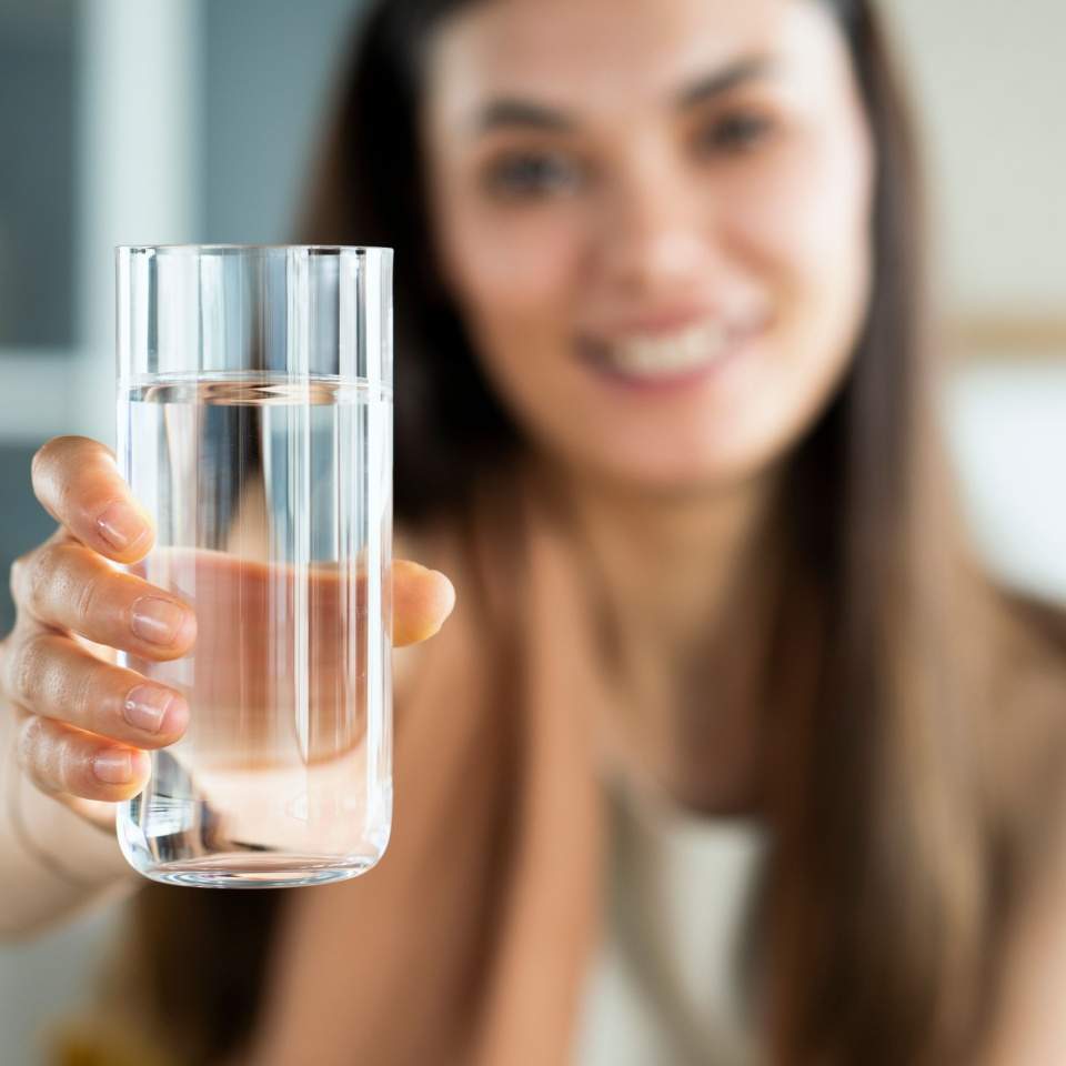 Young Woman Holding a Glass of Water