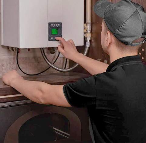 5050-What Water Heater Maintenance Services Are Offered - tech working on water heater